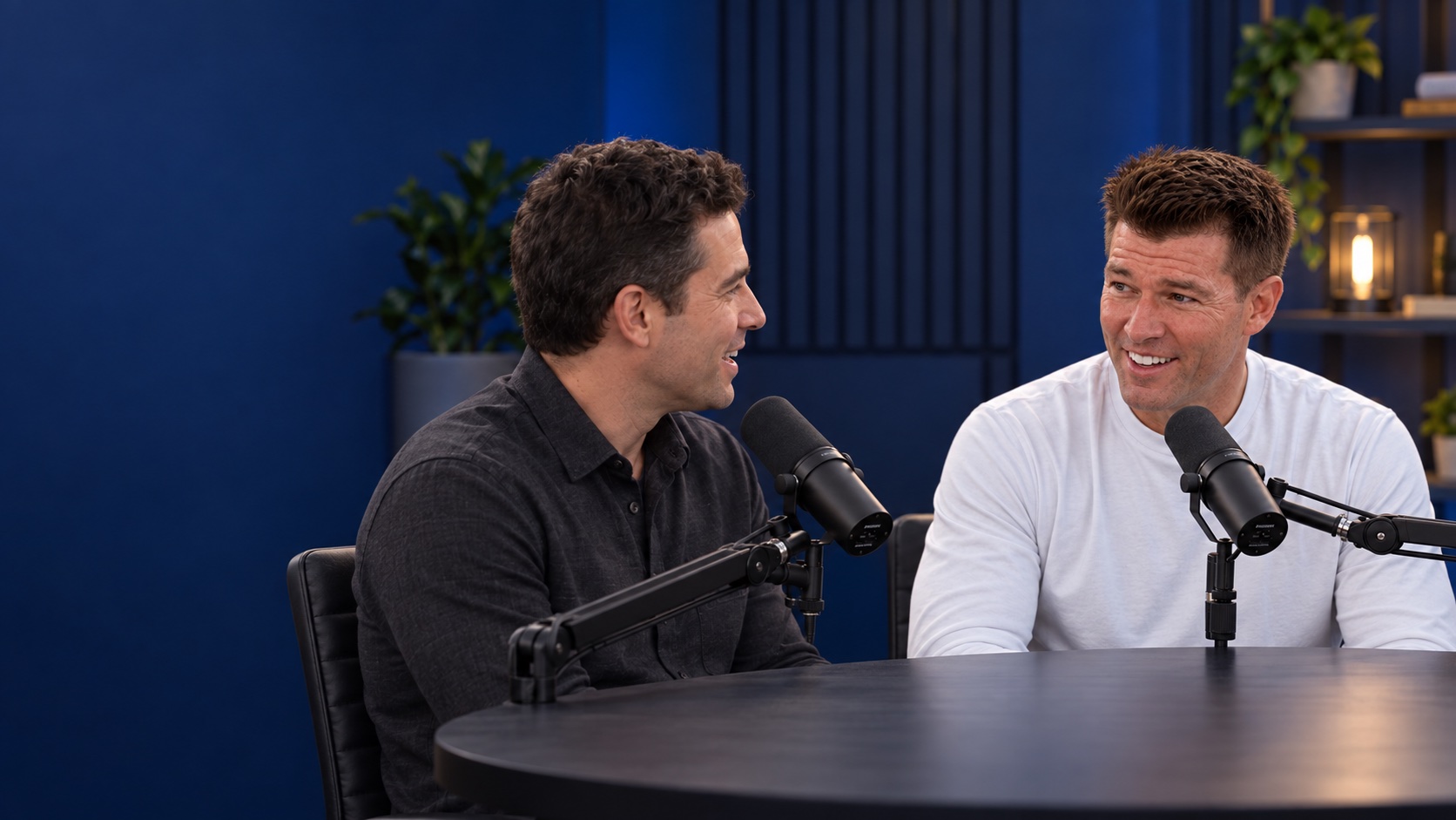 Ryan Penley and a guest sharing a conversation at podcast microphones